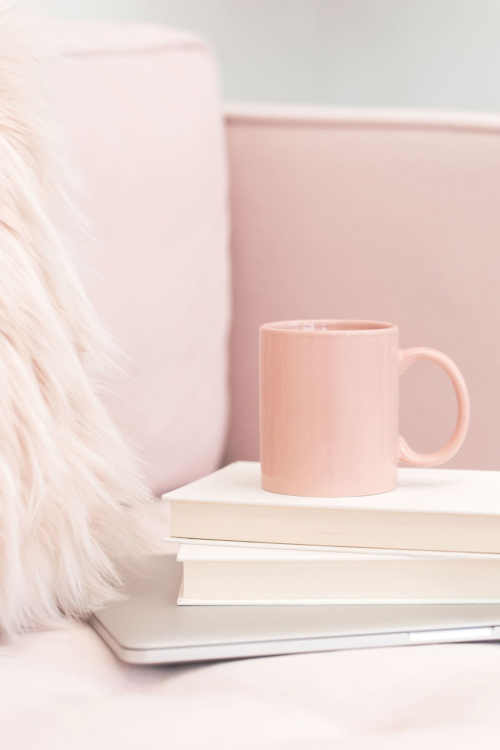 Laptop, journal, and books with a coffee mug, reflecting on creative growth.